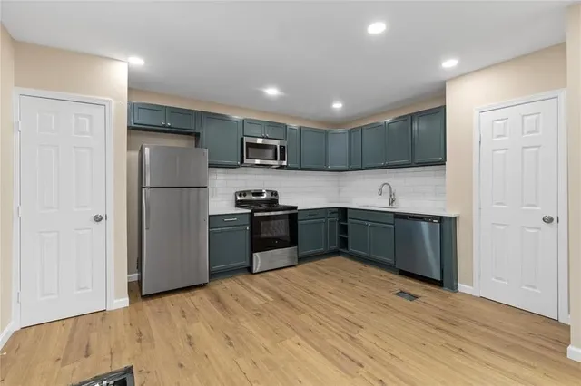 a kitchen with a refrigerator and a sink