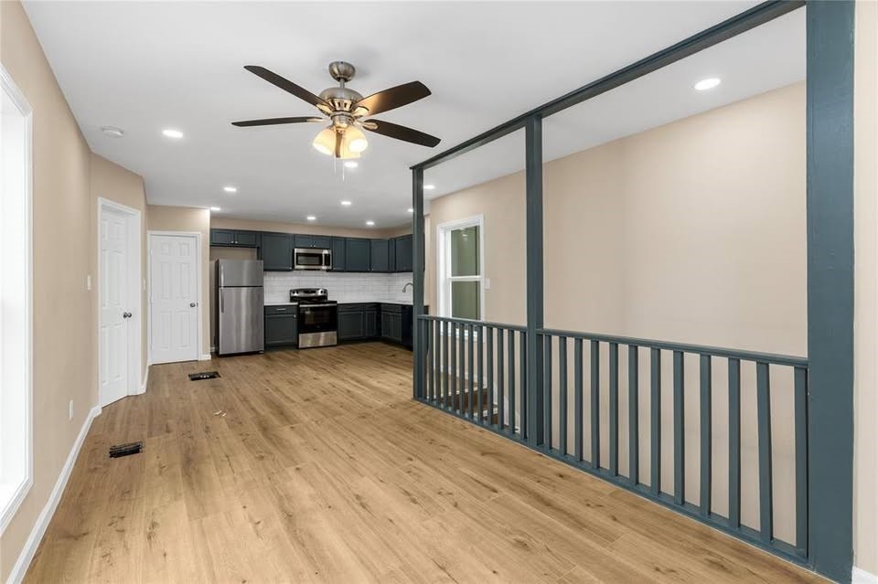 702 East Main Street Brenham, TX 77833 - Photo 4 of 7 a view of empty room with wooden floor and ceiling fan