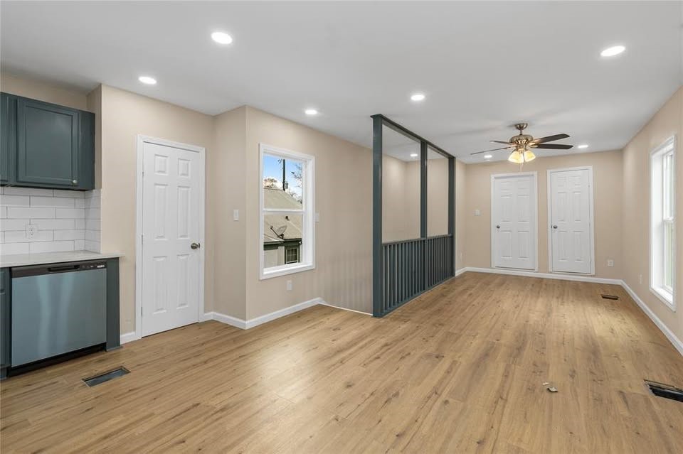 702 East Main Street Brenham, TX 77833 - Photo 5 of 7 a view of an empty room with wooden floor and a kitchen
