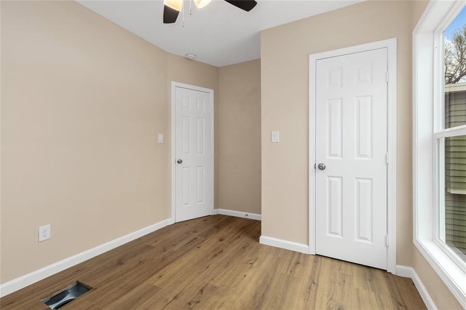 702 East Main Street Brenham, TX 77833 - Photo 6 of 7 an empty room with wooden floor and windows