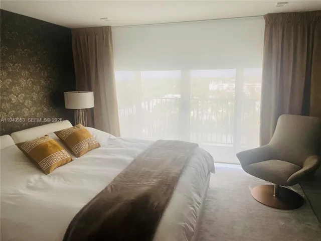 a bedroom with a bed and chair