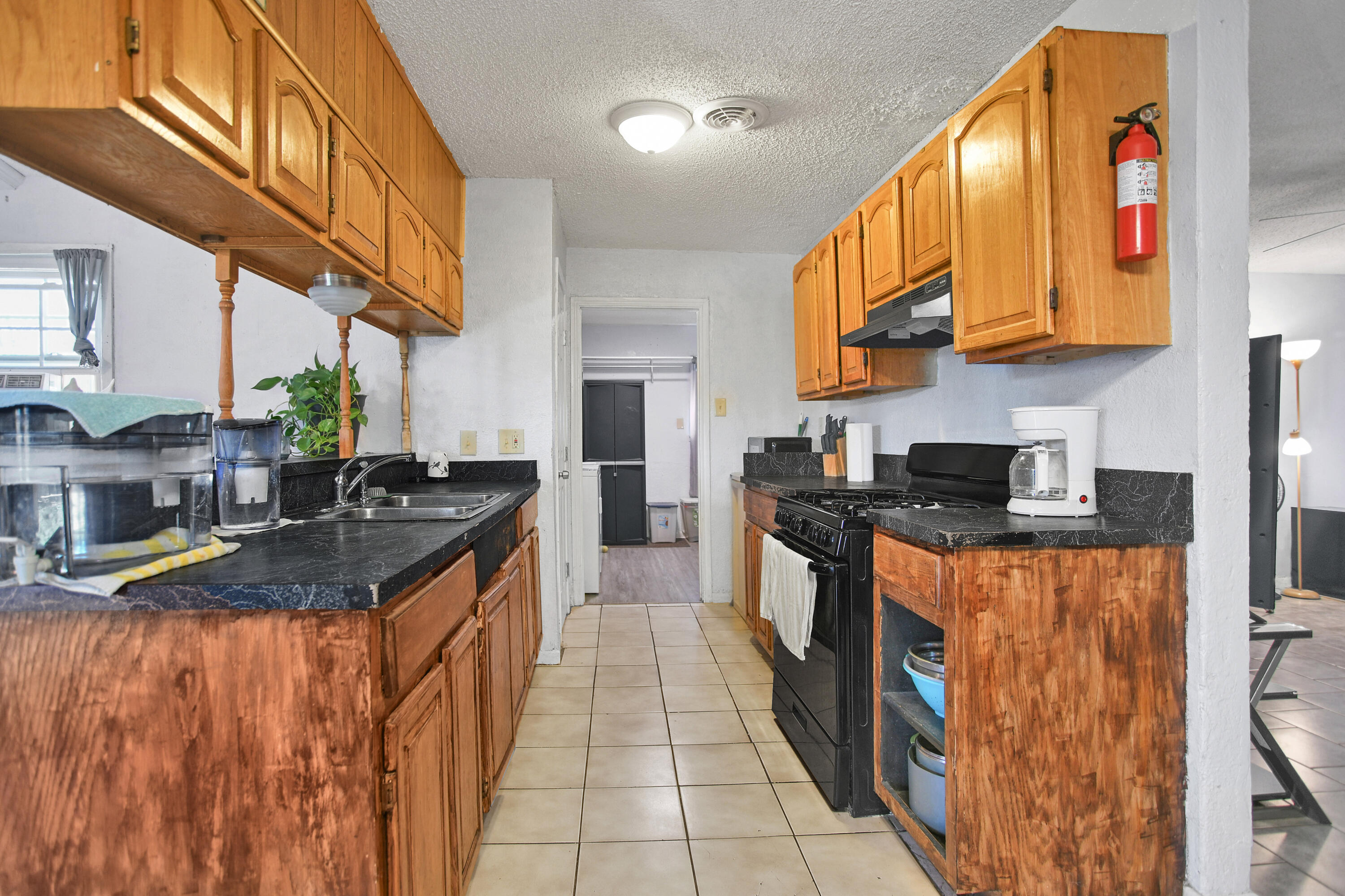 1810 East Colgate Street Lubbock, TX 79403 - Photo 11 of 40 a kitchen with stainless steel appliances granite countertop a stove and a sink