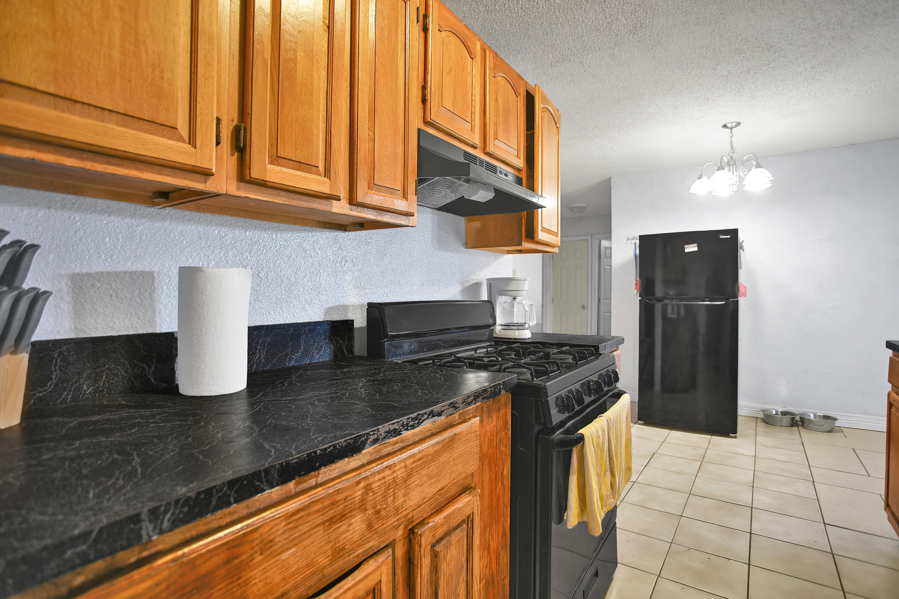 1810 East Colgate Street Lubbock, TX 79403 - Photo 12 of 40 a kitchen with granite countertop a stove and a refrigerator