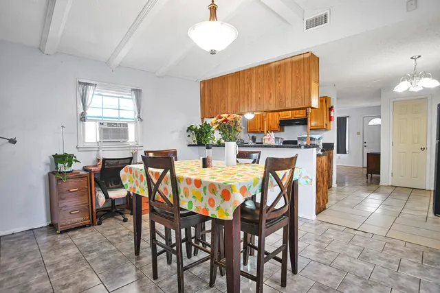 a dining room with furniture and window