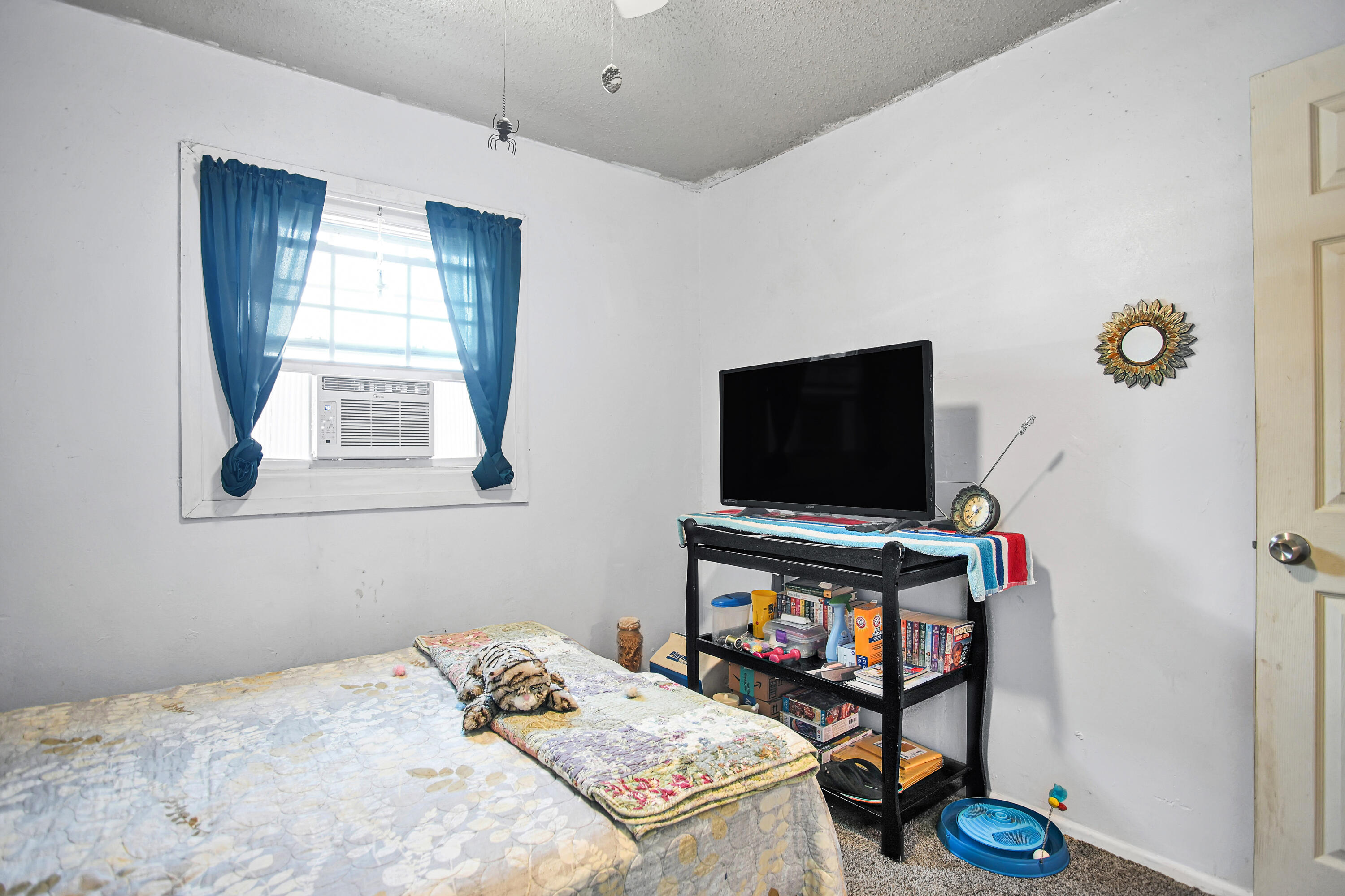 1810 East Colgate Street Lubbock, TX 79403 - Photo 28 of 40 a bedroom with a bed and a flat screen tv