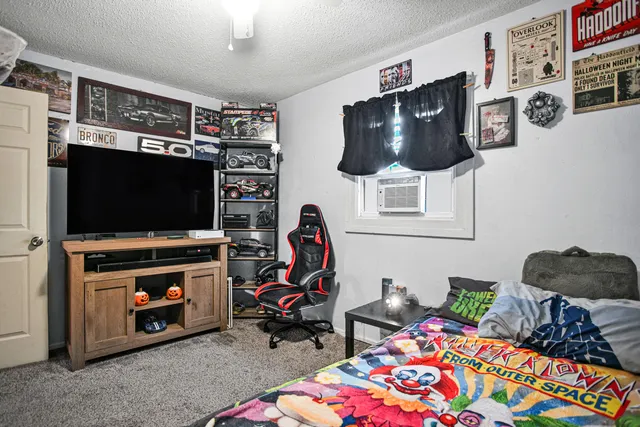 a bedroom with a bed and window