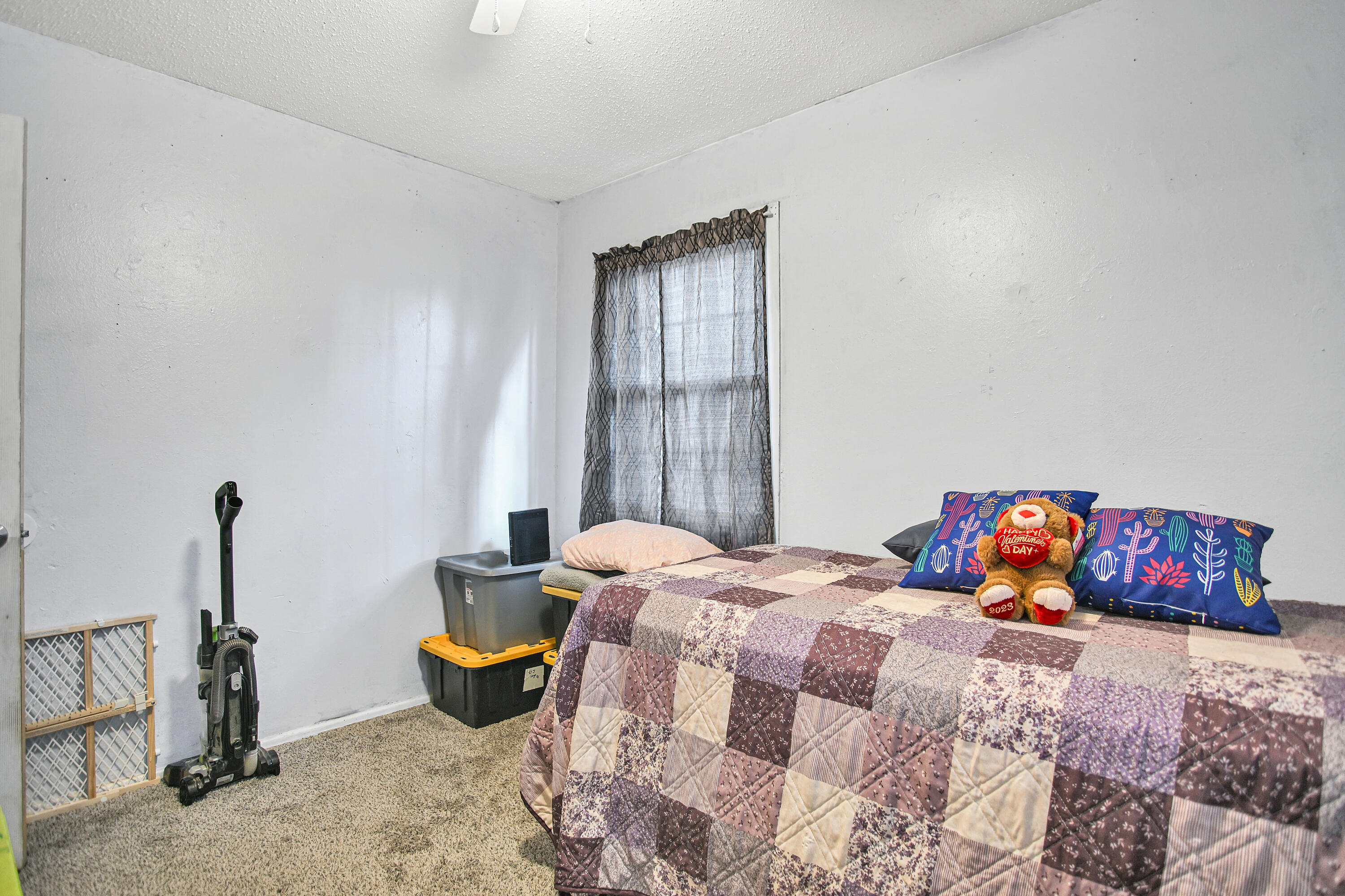 1810 East Colgate Street Lubbock, TX 79403 - Photo 34 of 40 a bedroom with a bed and wooden floor