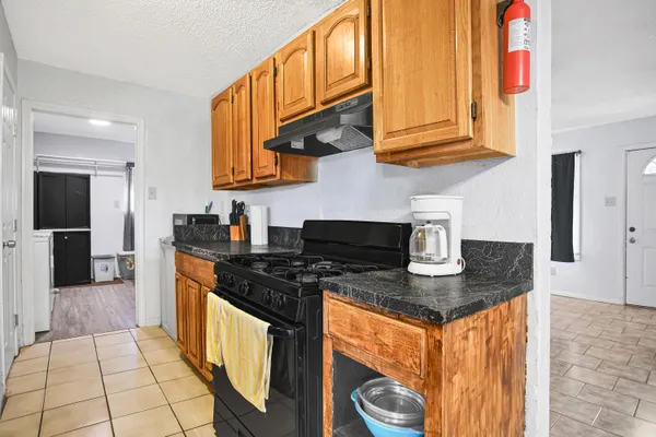 a kitchen with stainless steel appliances granite countertop a stove and a sink