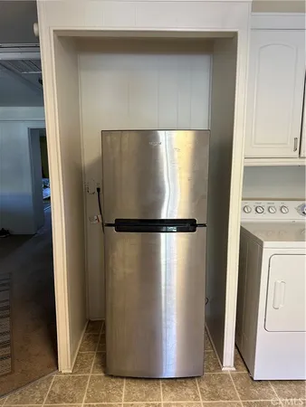 a view of a refrigerator in kitchen