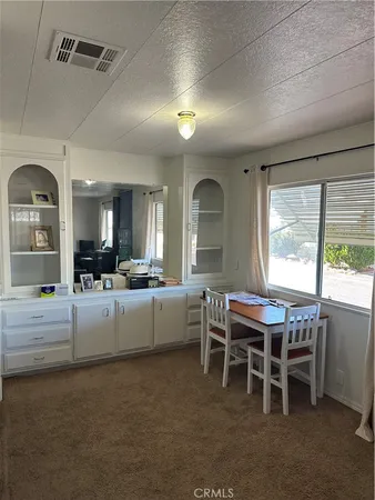 a view of a dining room with furniture and a window