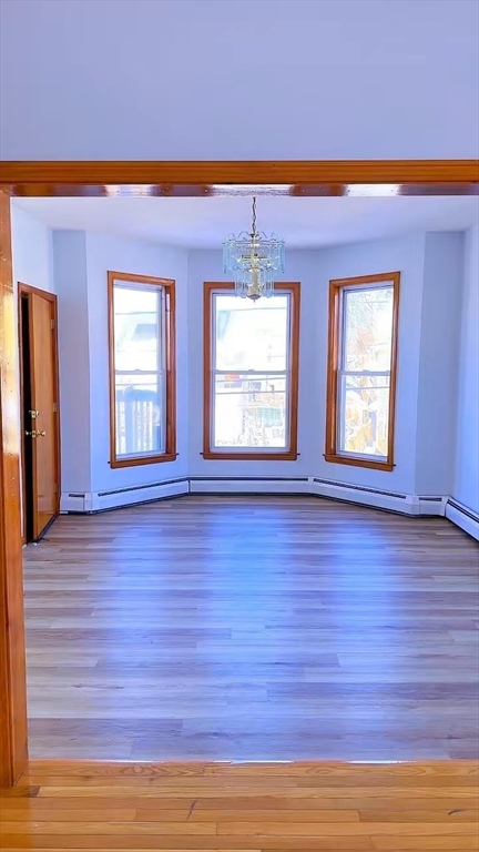 29 Hancock Street, Unit 2 Brockton, MA 02301 - Photo 4 of 6 a view of an empty room with wooden floor and a window