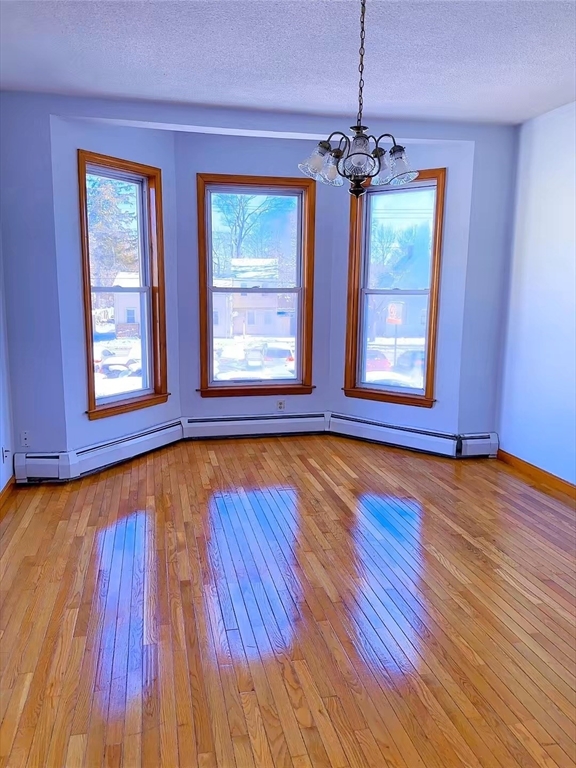 29 Hancock Street, Unit 2 Brockton, MA 02301 - Photo 5 of 6 a view of an empty room with wooden floor and a window