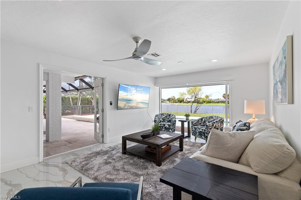 2500 Kings Lake Boulevard Naples, FL 34112 - Photo 11 of 31 a living room with furniture and a large window