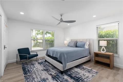 a bed room with a bed and a chair