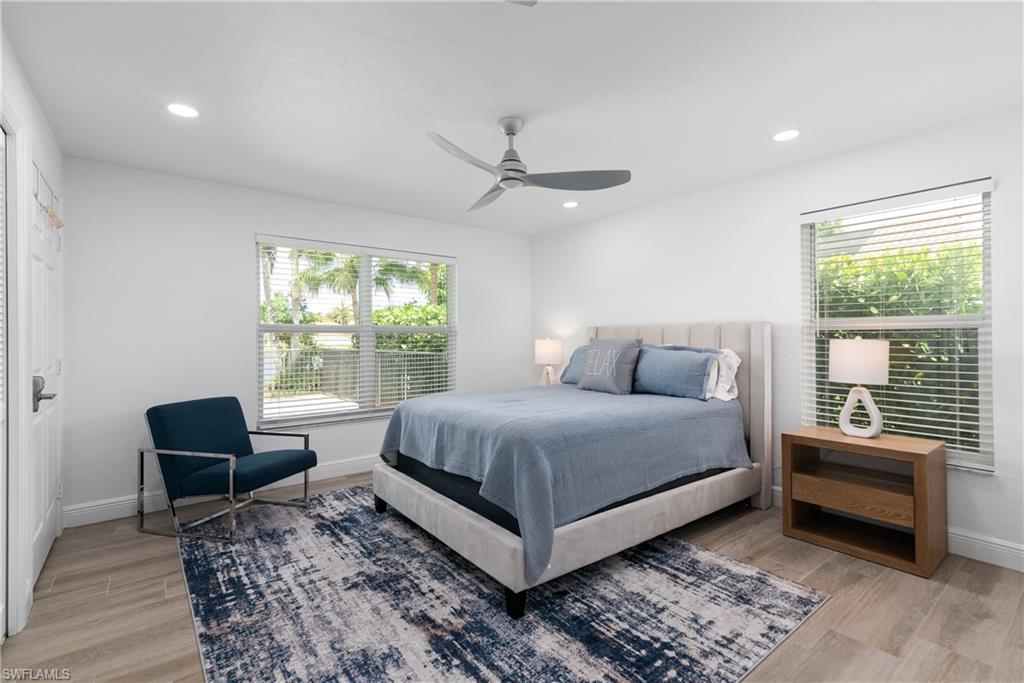 2500 Kings Lake Boulevard Naples, FL 34112 - Photo 16 of 31 a bed room with a bed and a chair