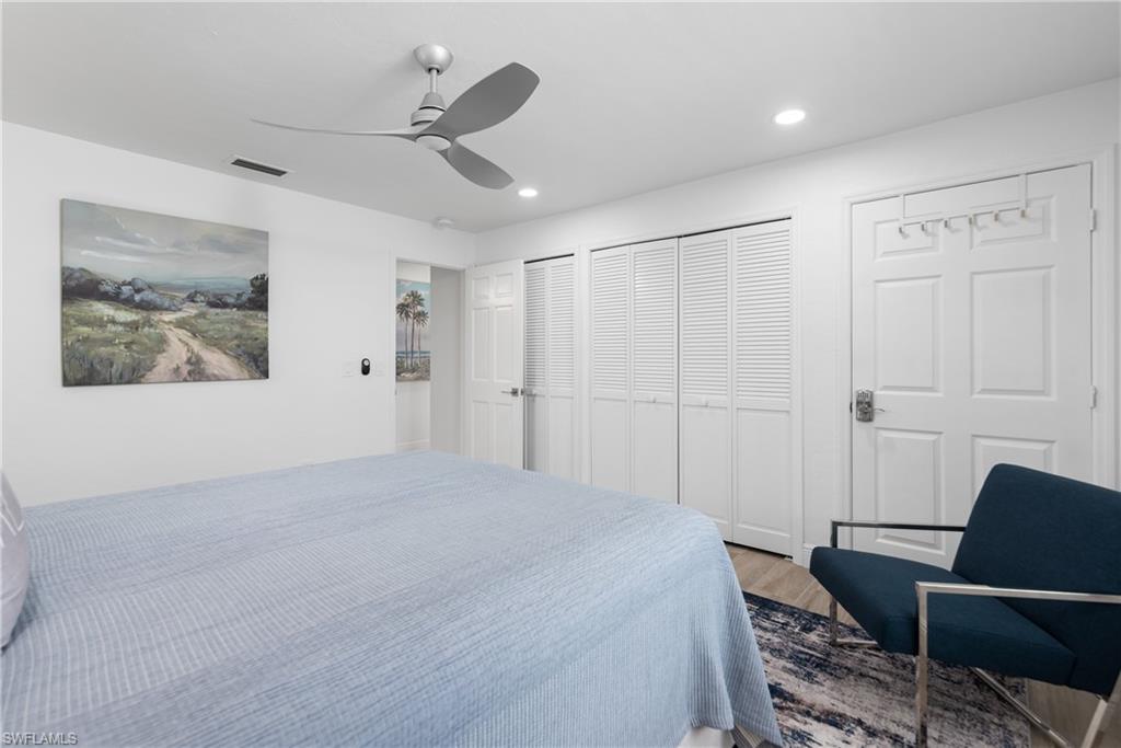 2500 Kings Lake Boulevard Naples, FL 34112 - Photo 17 of 31 a bedroom with a bed and furniture