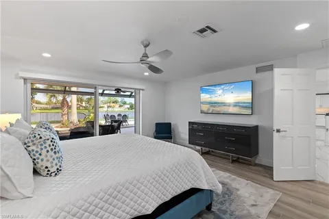 a bedroom with a large bed and a flat screen tv