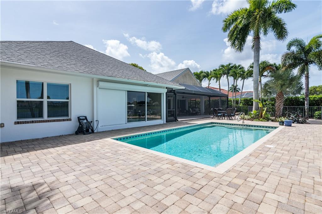 2500 Kings Lake Boulevard Naples, FL 34112 - Photo 25 of 31 a view of a house with swimming pool and a yard