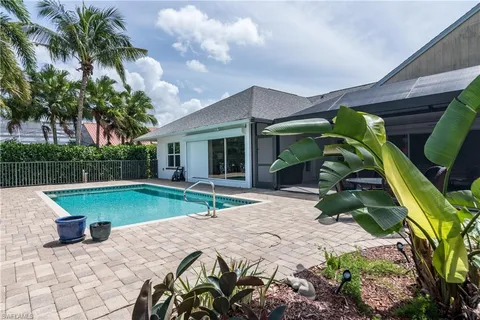 a view of a house with backyard and sitting area