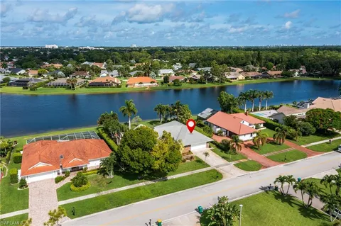 an aerial view of a house with a lake view