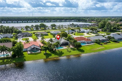 an aerial view of a house with a garden and lake view