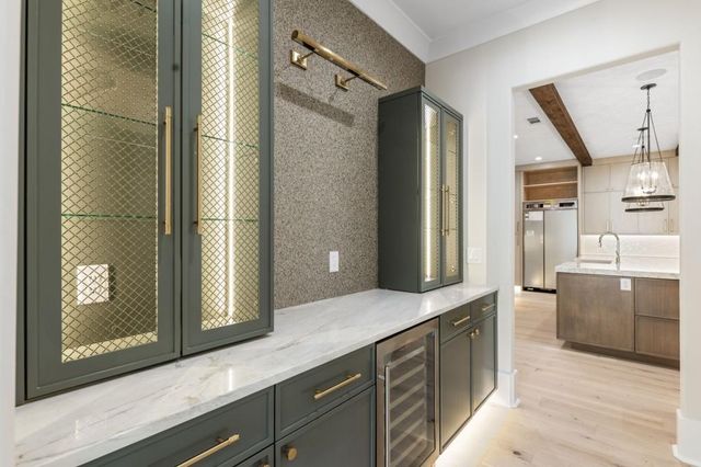 a large kitchen with stainless steel appliances a sink and cabinets