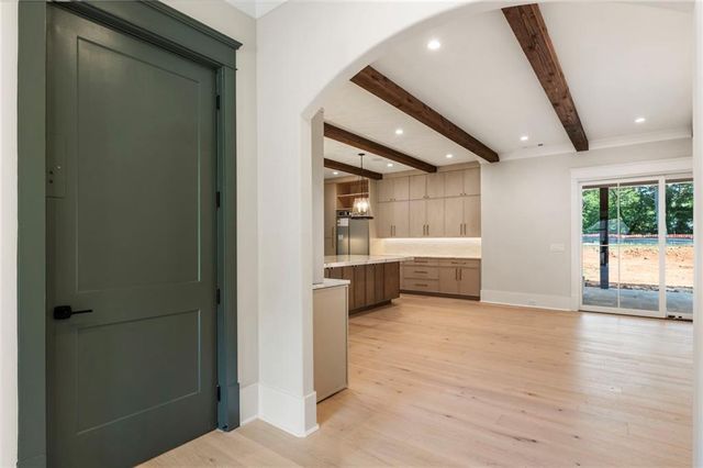 a kitchen with white cabinets and white appliances