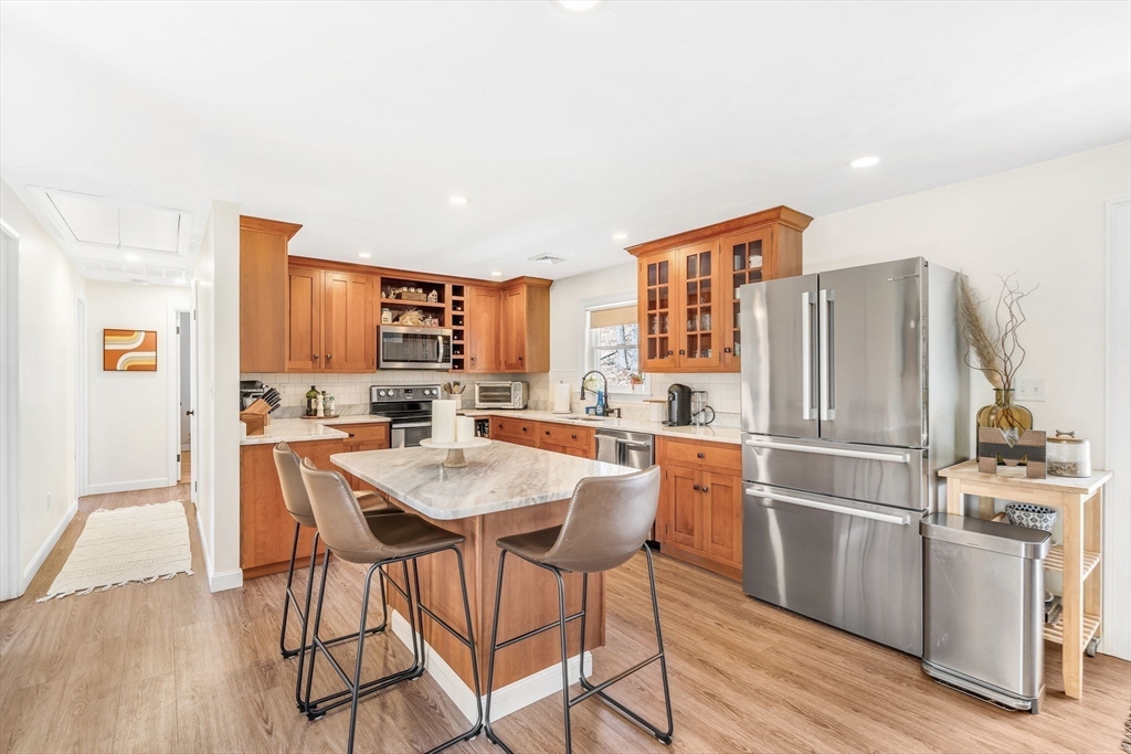 137 Harvard Road Stow, MA 01775 - Photo 8 of 18 a kitchen with stainless steel appliances granite countertop a refrigerator and a stove top oven