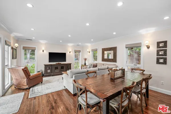 a living room with furniture a flat screen tv and a table