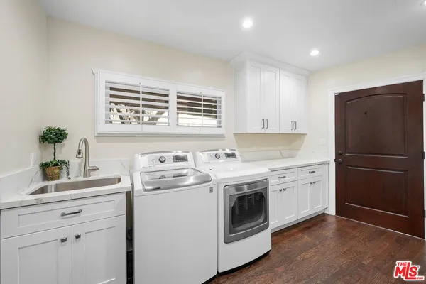 a kitchen with a stove sink and refrigerator