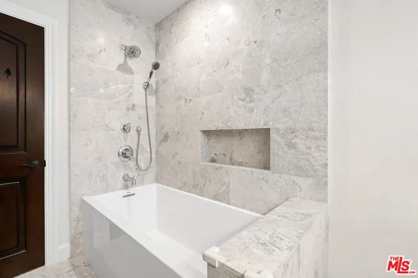 a bath tub sitting next to a bathroom sink