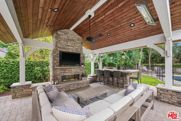 a outdoor living space with patio furniture and a fireplace
