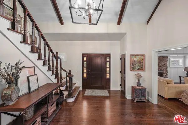 a living room with wooden floor and stairs
