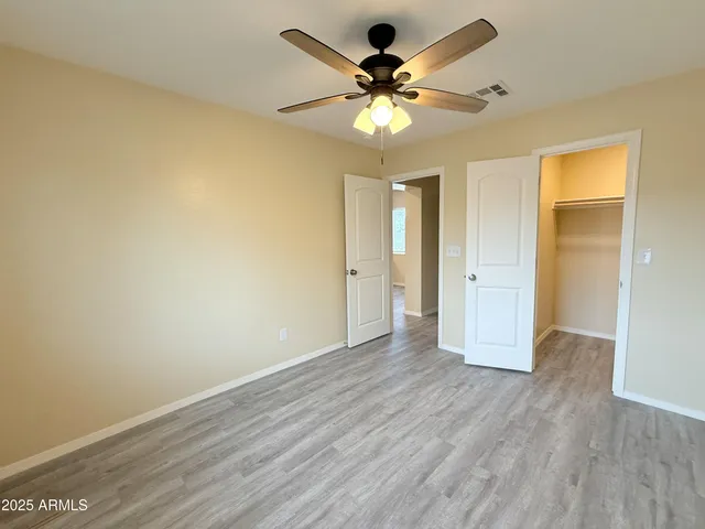 a view of an empty room and wooden floor