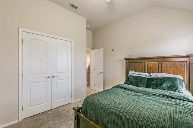 a bedroom with a bed and walk in closet