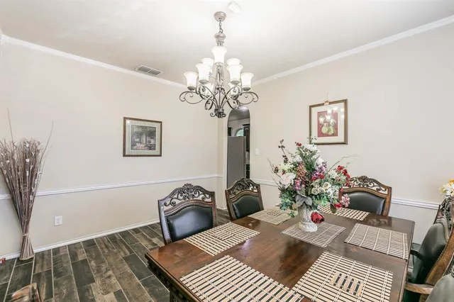 a living room with furniture a chandelier and a table