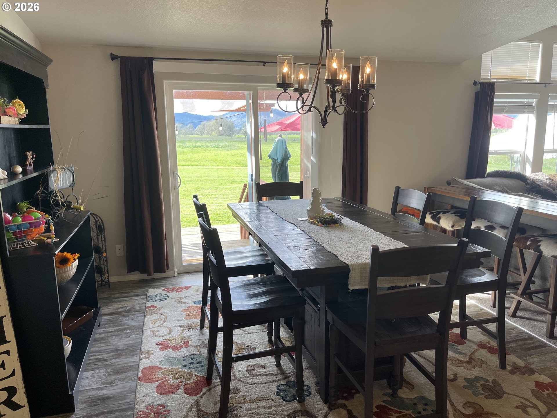 6404 Lookingglass Road Roseburg, OR 97471 - Photo 16 of 48 a view of a dining room with furniture and chandelier