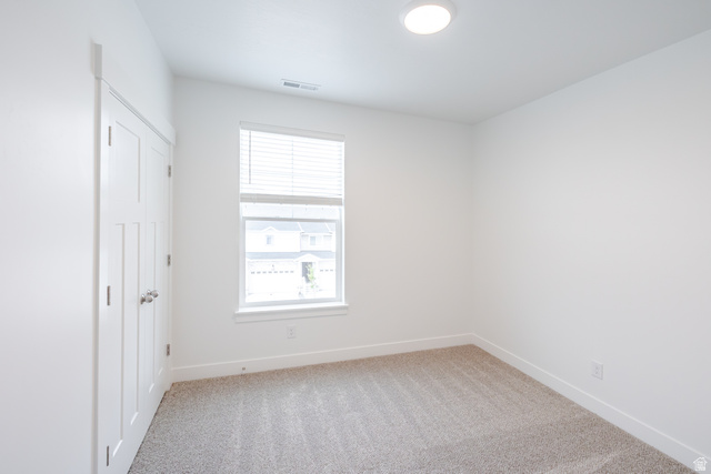 693 West 4500th South, Unit O301 Mapleton, UT 84664 - Photo 7 of 16 Unfurnished bedroom with light colored carpet and a closet