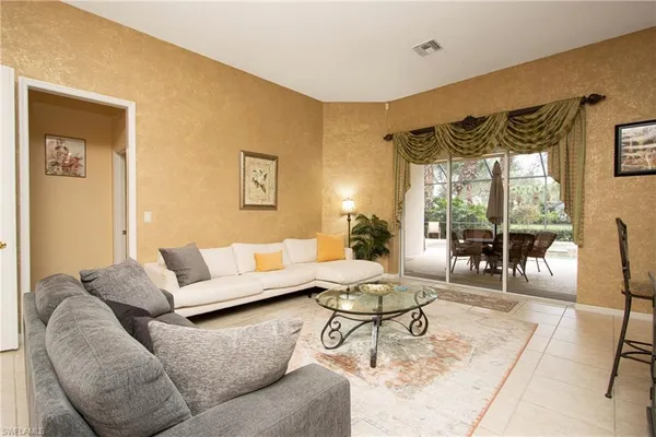 a living room with furniture and a large window