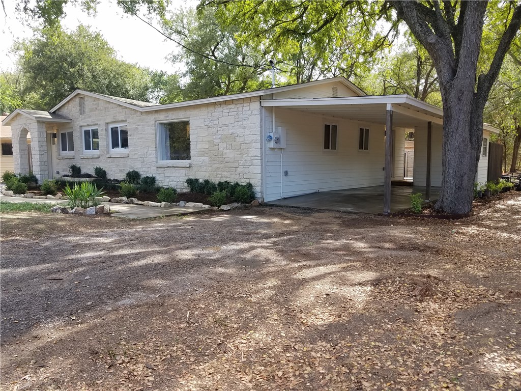 5405 Hudson Street Austin, TX 78721 - Photo 2 of 37 A charming single-story residence with a stone facade and a convenient covered carport.