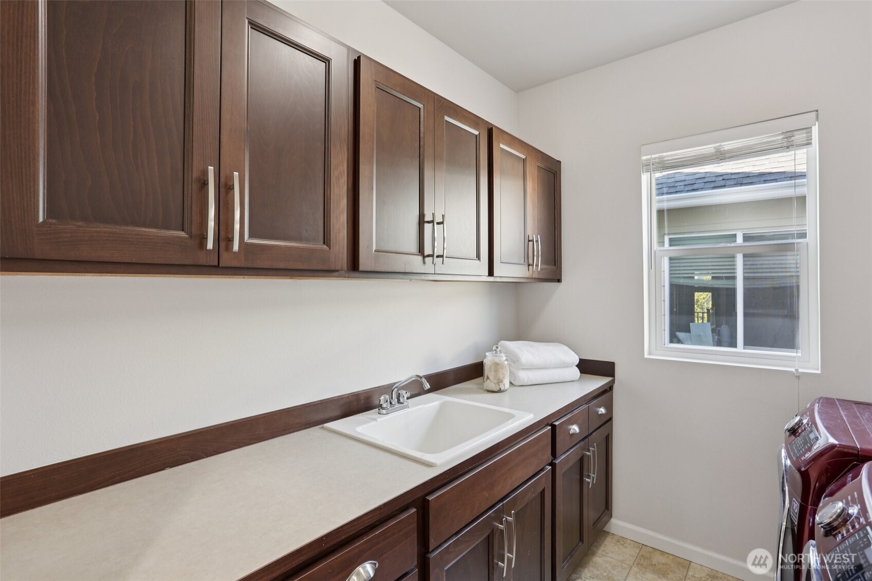 19817 35th Drive Southeast Bothell, WA 98012 - Photo 17 of 34 a utility room with granite countertop cabinets washer and dryer