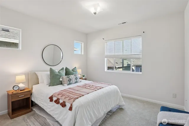 a bedroom with a bed and a painting on the wall