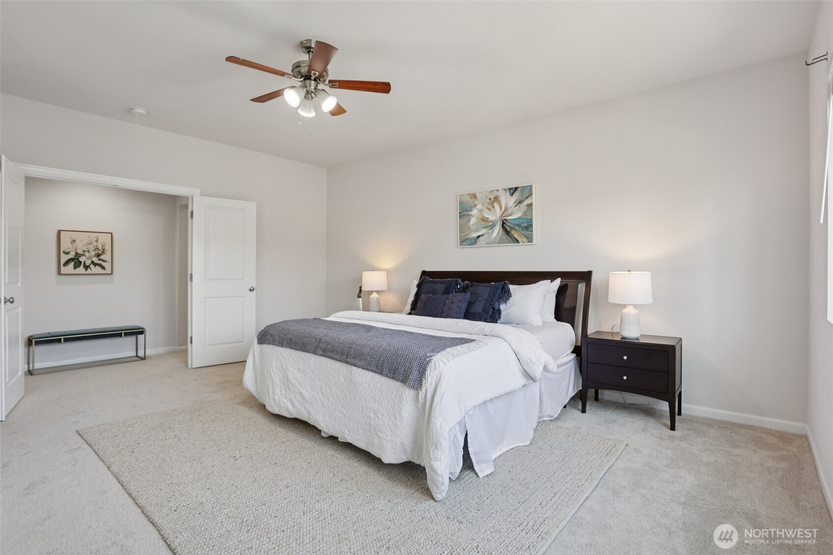 19817 35th Drive Southeast Bothell, WA 98012 - Photo 21 of 34 a spacious bedroom with a bed and a ceiling fan