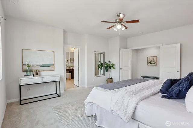 a bedroom with a large bed and a chandelier