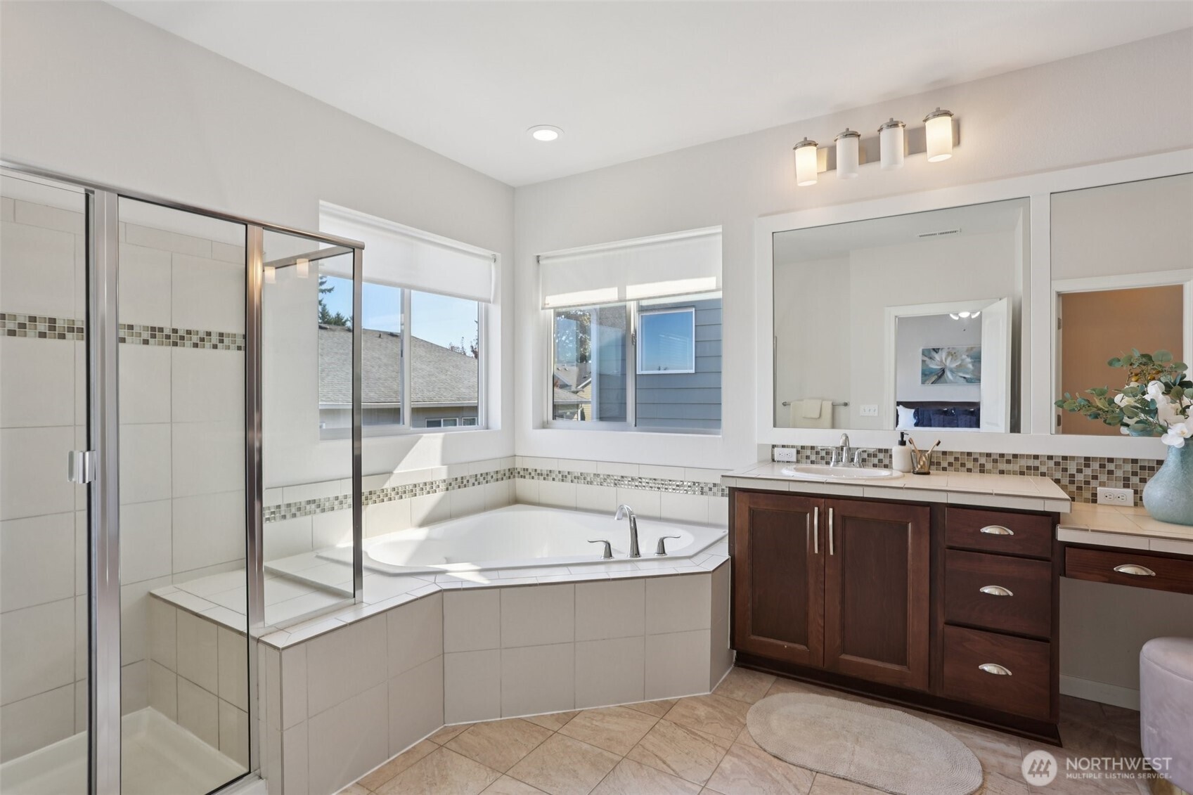 19817 35th Drive Southeast Bothell, WA 98012 - Photo 24 of 34 a bathroom with a granite countertop tub sink shower and mirror