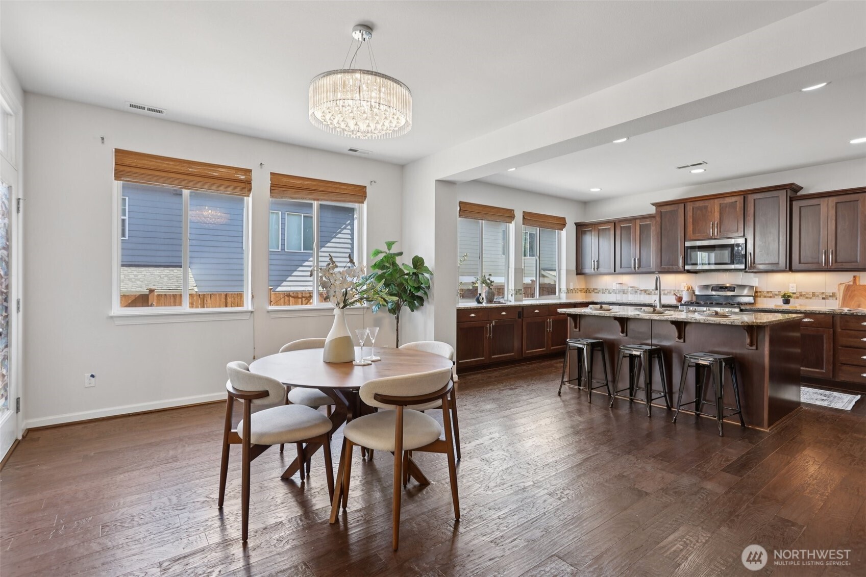 19817 35th Drive Southeast Bothell, WA 98012 - Photo 4 of 34 a room with stainless steel appliances kitchen island granite countertop furniture and a dining table with wooden floor