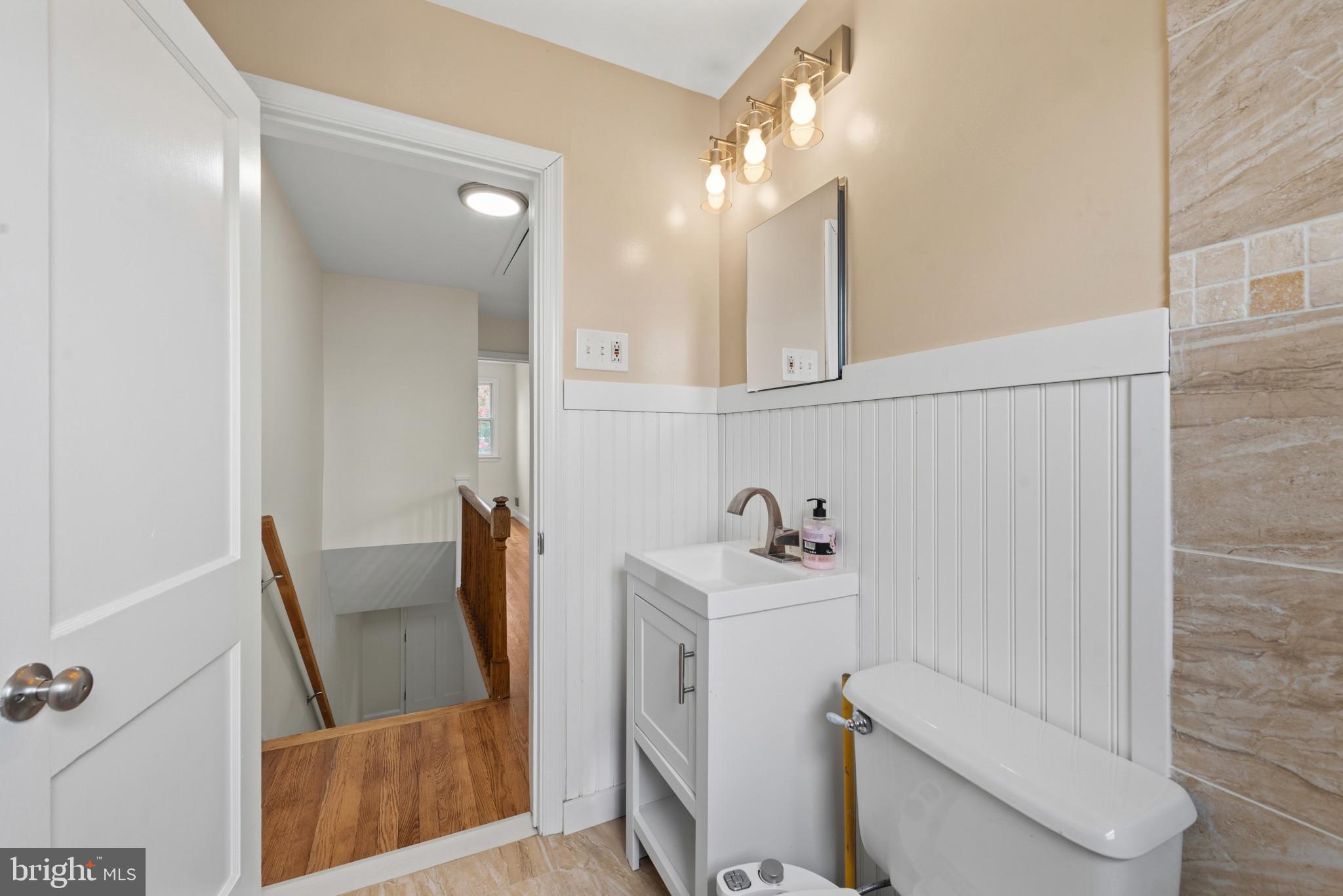 2207 Hawthorne Road Baltimore, MD 21220 - Photo 16 of 39 a bathroom with a sink toilet and mirror