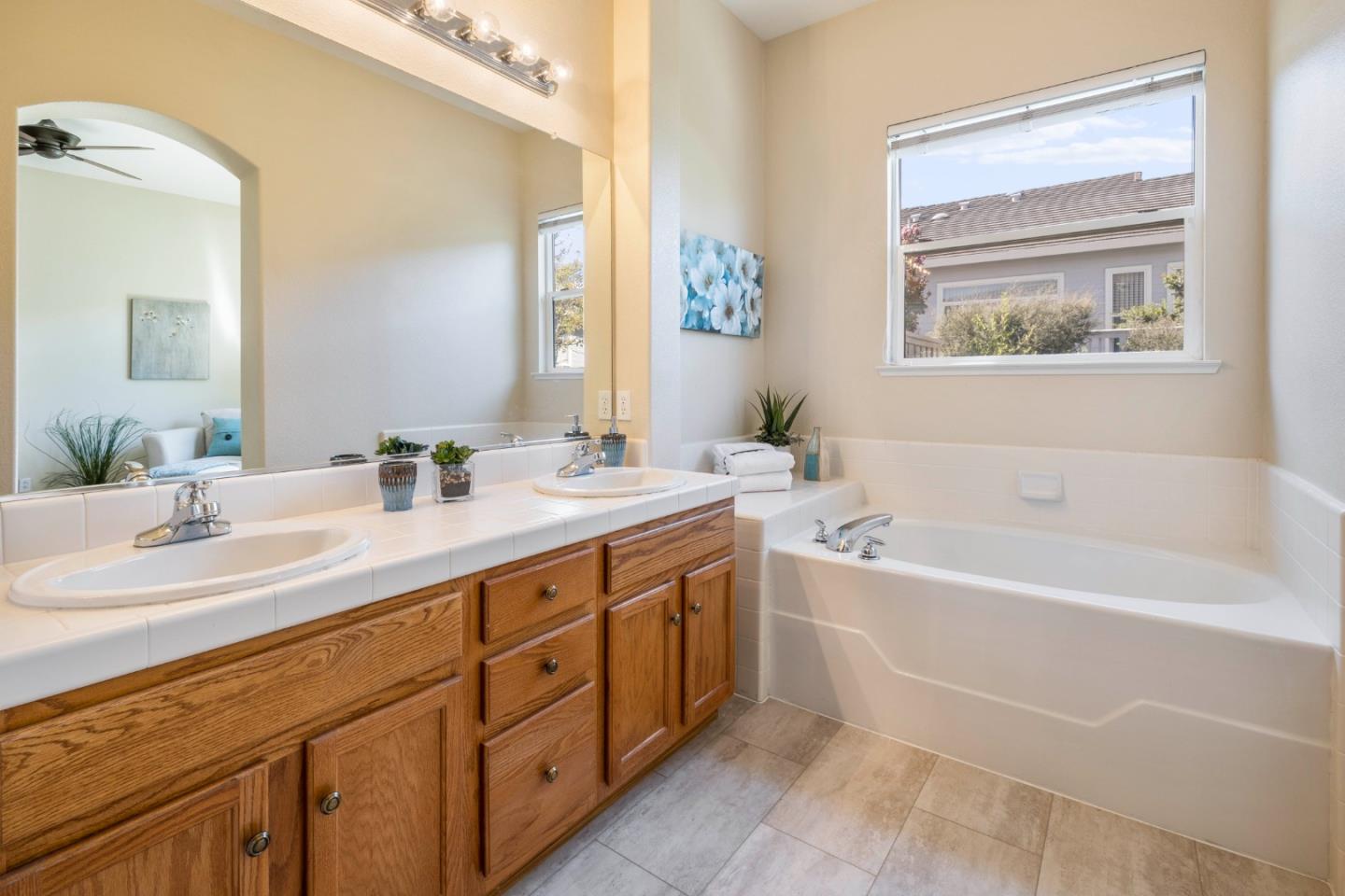2016 Carignan Way San Jose, CA 95135 - Photo 16 of 44 a bathroom with a tub a sink and a mirror