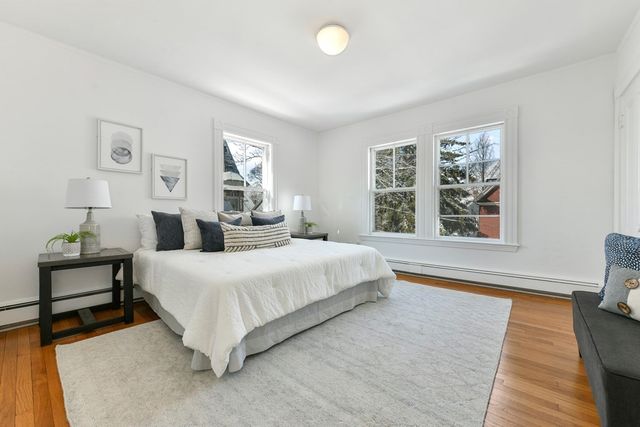 a bedroom with a large bed and a window