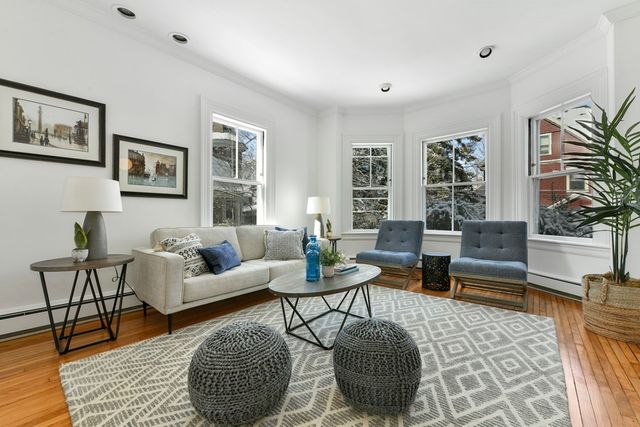 a living room with furniture and a rug